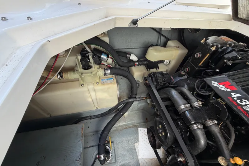 Slide: The Image of Engine compartment of a 2001 Sea Ray Sundancer 280, showcasing mechanical components and wiring. - 26