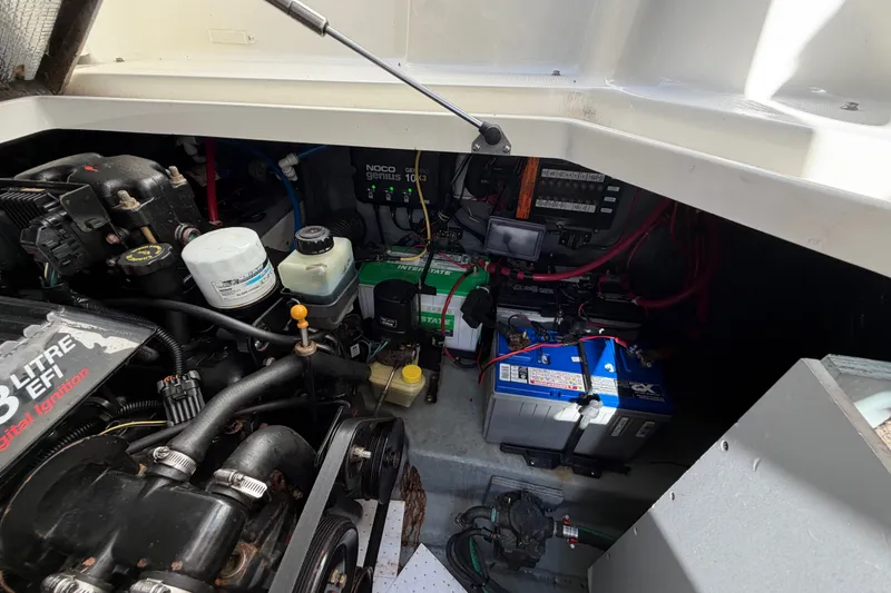 Slide: The Image of Engine compartment of a 2001 Sea Ray Sundancer 280, featuring batteries and mechanical components. - 27