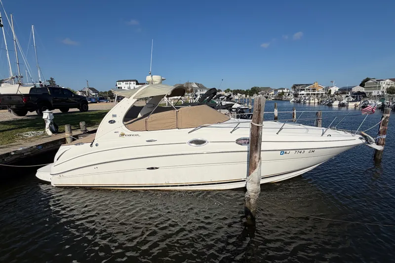 The Image of 2001 Sea Ray Sundancer 280 docked in a marina under clear blue skies. - 0