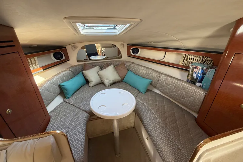 Slide: The Image of Interior of 2001 Sea Ray Sundancer 280, featuring cozy seating and elegant wood finishes. - 21