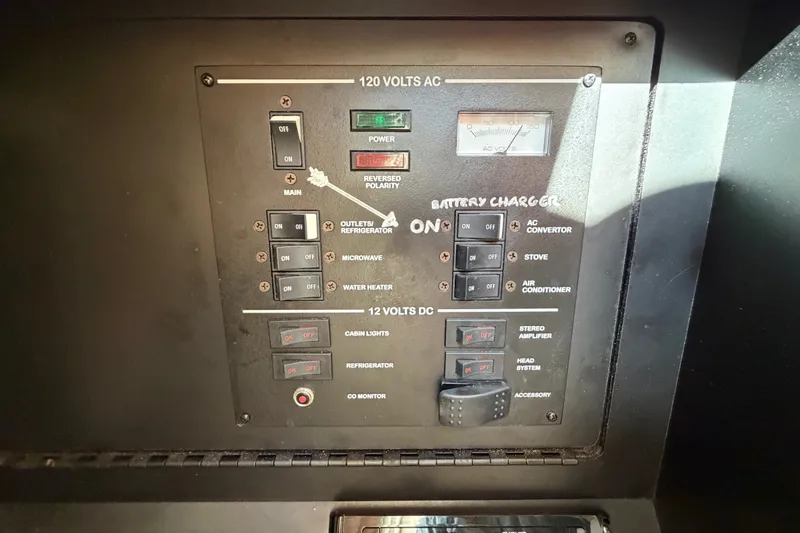 Slide: The Image of Control panel of a 2001 Sea Ray Sundancer 280 boat, featuring various switches and indicators. - 31