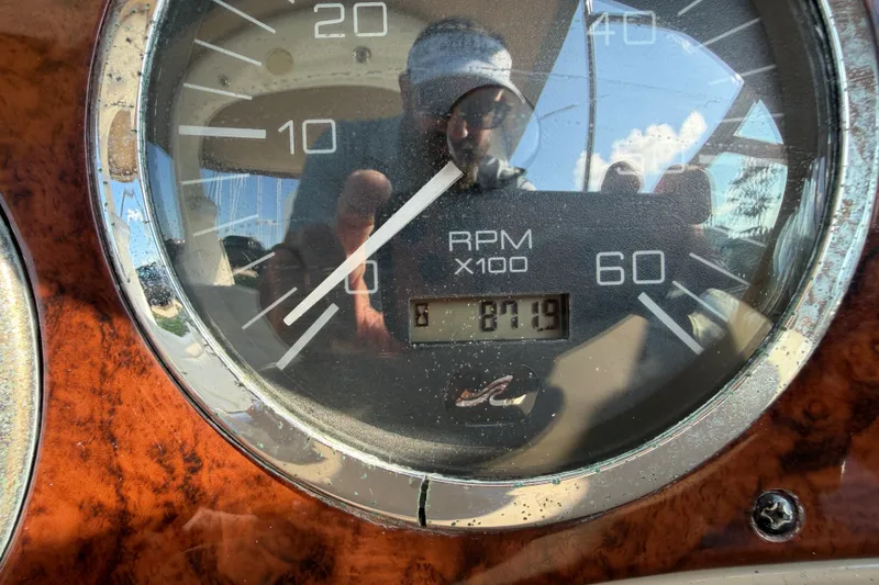 Slide: The Image of Close-up of a Sea Ray Sundancer 280 tachometer showing 871.9 RPM. - 28