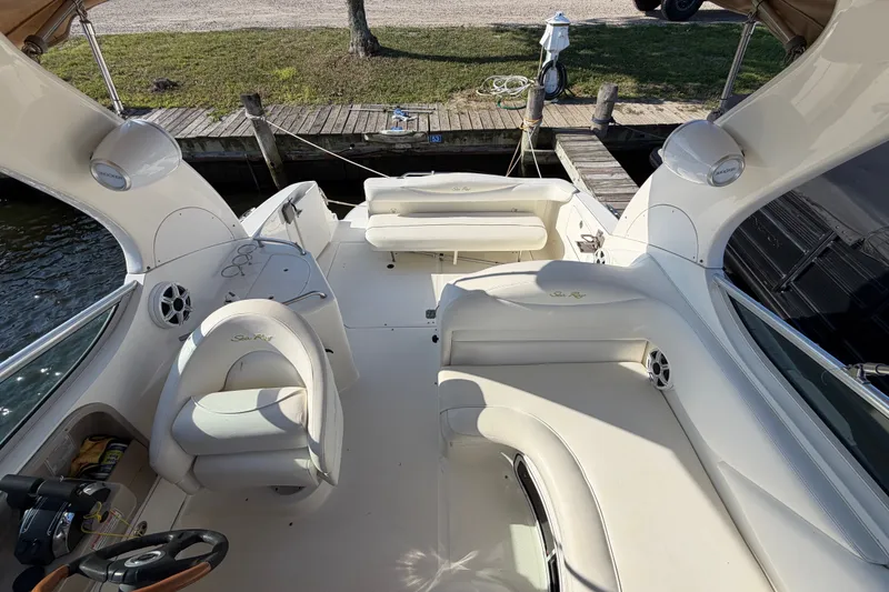 Slide: The Image of 2001 Sea Ray Sundancer 280 boat interior with white seating and steering wheel. - 15
