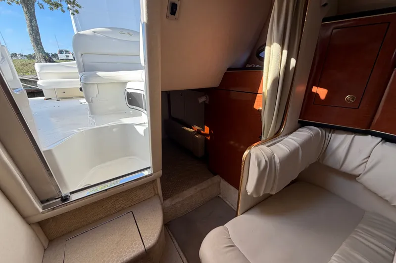 Slide: The Image of Interior view of 2001 Sea Ray Sundancer 280, showcasing seating and cabinetry. - 23