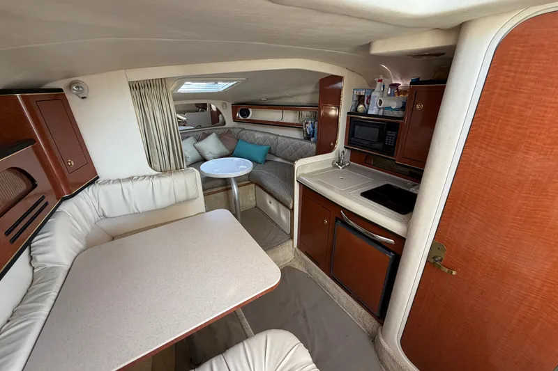 Slide: The Image of Interior of 2001 Sea Ray Sundancer 280 yacht with kitchenette and seating area. - 18