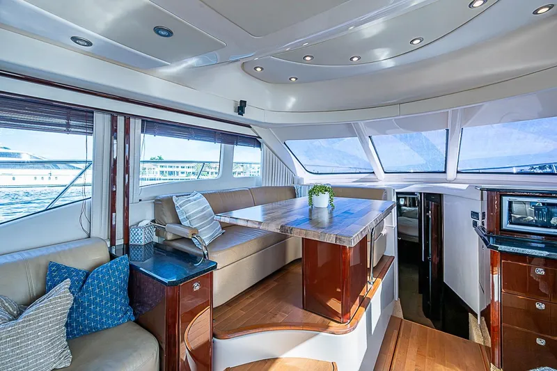 Slide: The Image of Luxurious interior of 2010 Sea Ray 520 Sedan Bridge yacht with elegant seating and dining area. - 47