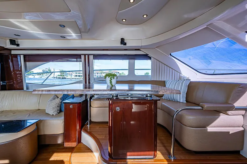 Slide: The Image of Luxurious interior of 2010 Sea Ray 520 Sedan Bridge yacht with elegant seating and panoramic windows. - 43