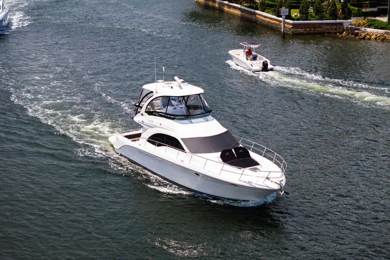 Slide: The Image of 2010 Sea Ray 52 Sedan Bridge yacht cruising on a scenic waterway. - 15