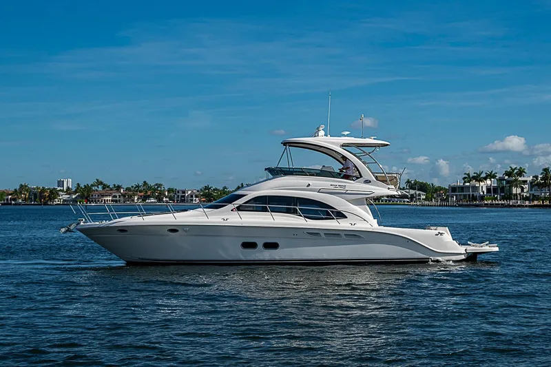 Slide: The Image of 2010 Sea Ray 520 Sedan Bridge yacht cruising on a sunny day. - 11