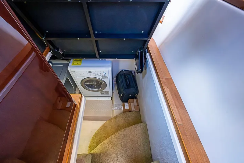 Slide: The Image of Laundry area in 2010 Sea Ray 520 Sedan Bridge with washer and storage space. - 59