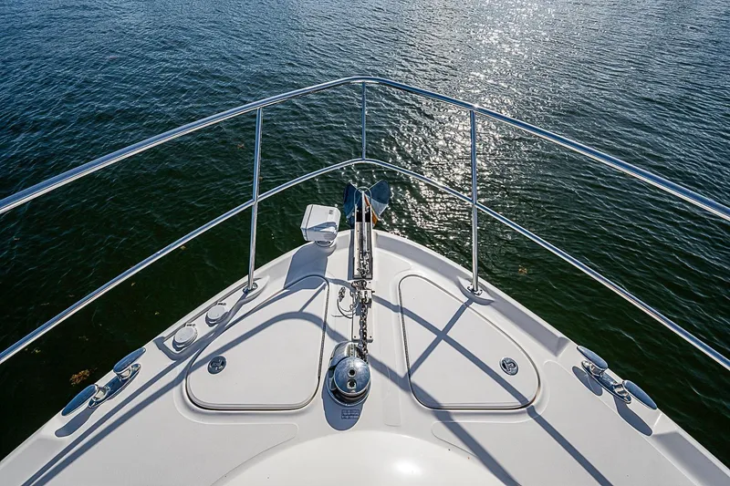 Slide: The Image of Bow view of 2010 Sea Ray 520 Sedan Bridge yacht on calm water. - 21