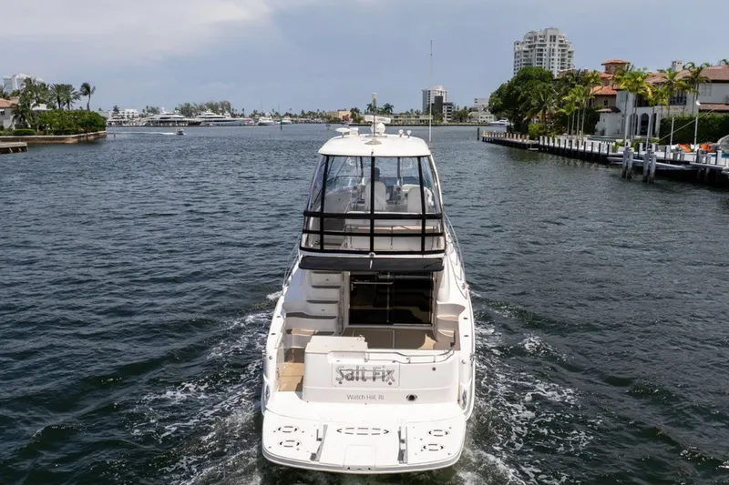 Slide: The Image of 2010 Sea Ray 52 Sedan Bridge yacht cruising on a scenic waterway. - 16