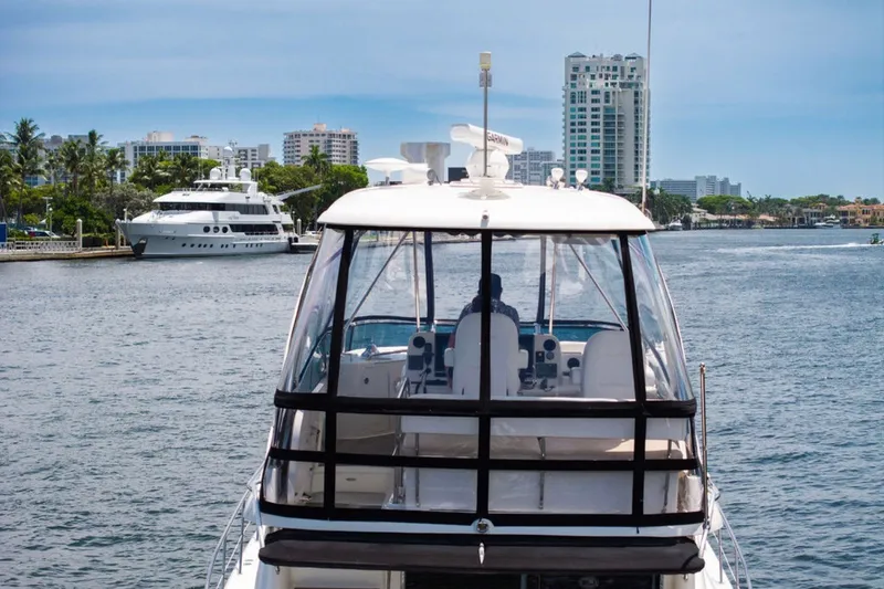 Slide: The Image of 2010 Sea Ray 52 Sedan Bridge yacht cruising near city waterfront. - 40