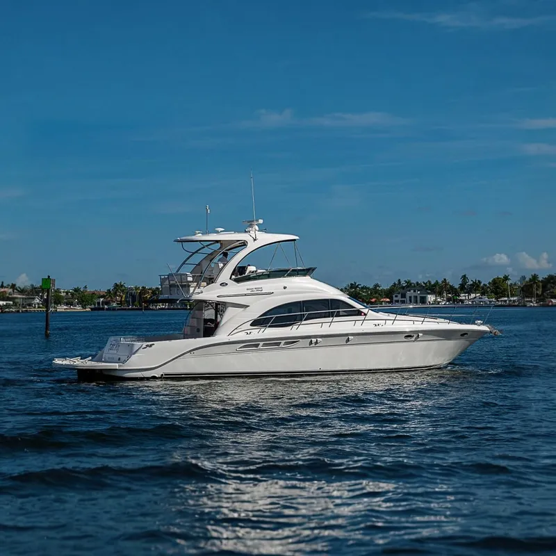 Slide: The Image of 2010 Sea Ray 520 Sedan Bridge yacht cruising on a sunny day. - 2