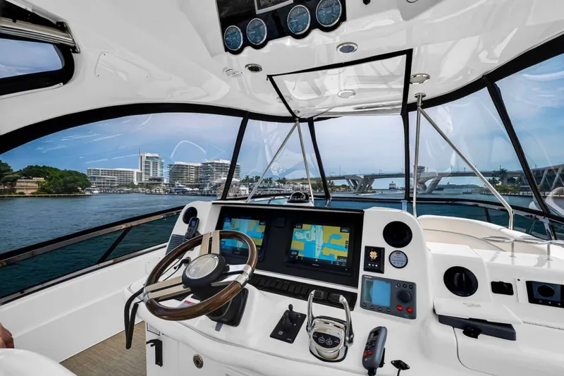 Slide: The Image of Helm of 2010 Sea Ray 52 Sedan Bridge yacht with navigation screens and controls. - 24