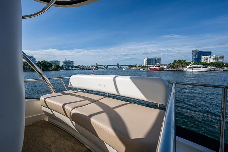 Slide: The Image of 2010 Sea Ray 520 Sedan Bridge yacht with waterfront cityscape view. - 36