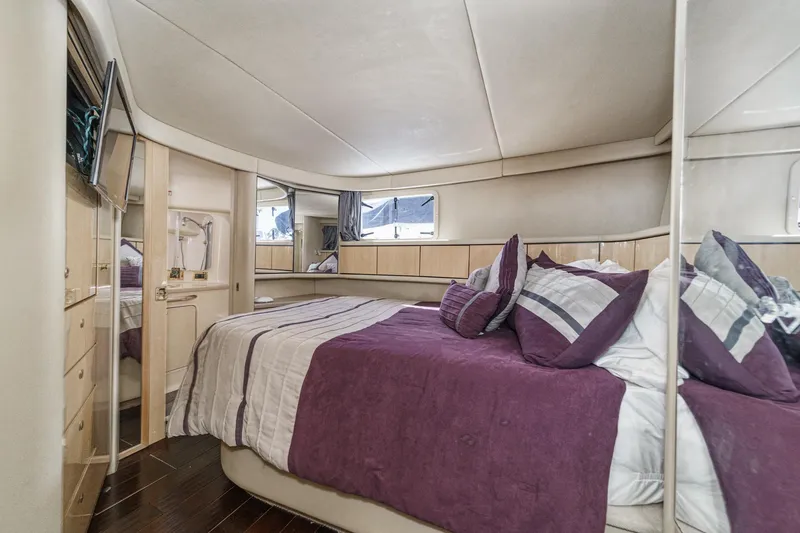 Slide: The Image of The image shows a cozy cabin with a large bed, purple bedding, and wooden furnishings. - 44