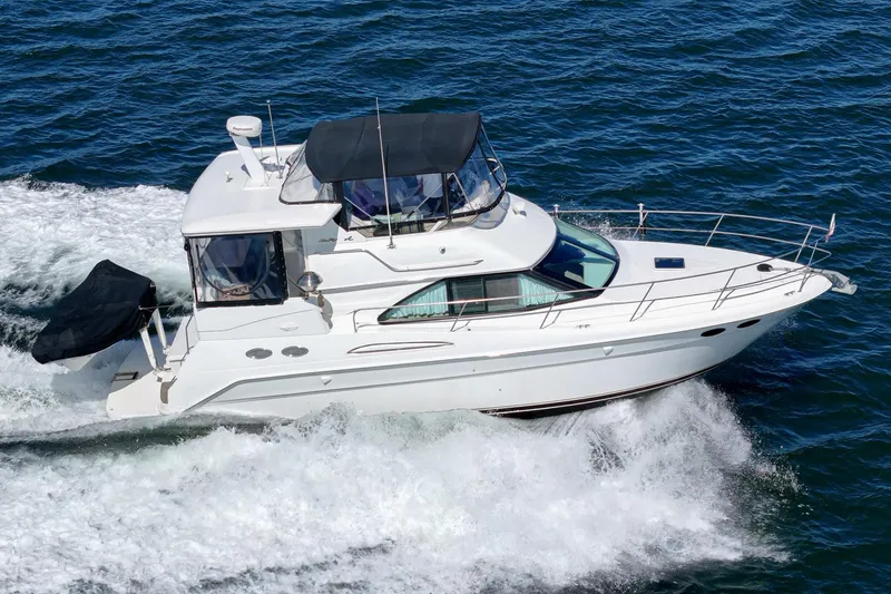 Slide: The Image of A white motor yacht speeds across the water. It features a covered helm and multiple windows. - 4