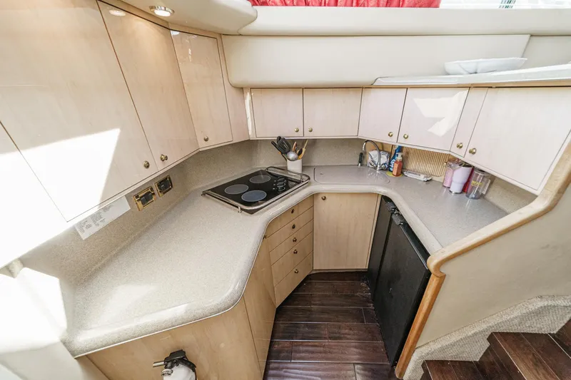 Slide: The Image of Galley of the 1999 Sea Ray 370 Aft Cabin with stove, refrigerator, and cabinets. - 39