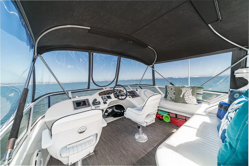 Slide: The Image of The image shows the cockpit of a 1999 Sea Ray 370 Aft Cabin with white seats and a black canopy. - 21