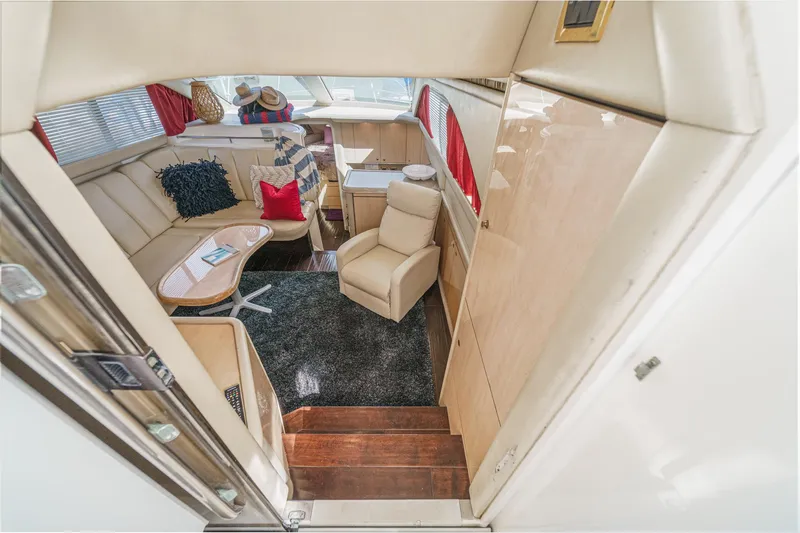Slide: The Image of Interior of a 1999 Sea Ray 370 Aft Cabin with beige sofa and carpet. - 22