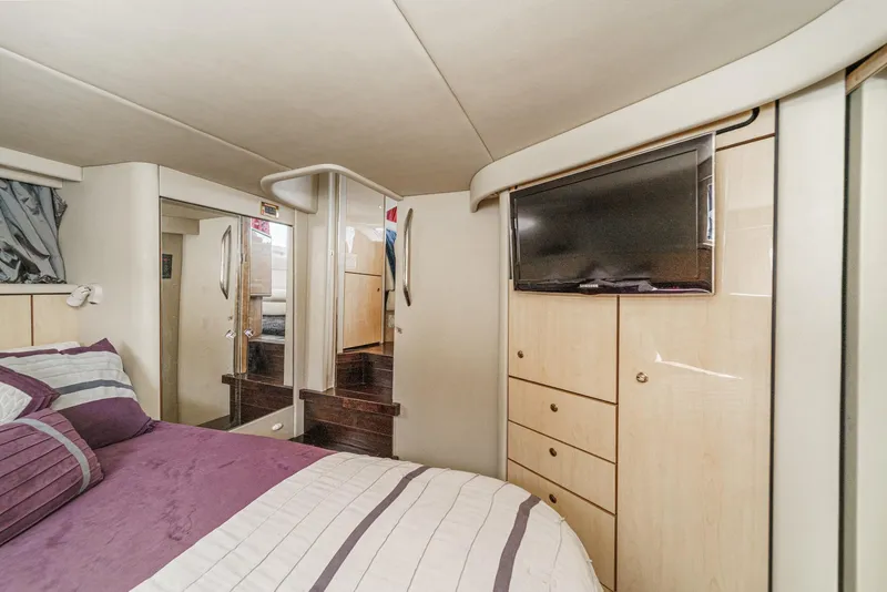 Slide: The Image of The image shows a cozy cabin with a bed, TV, and cabinets. - 38