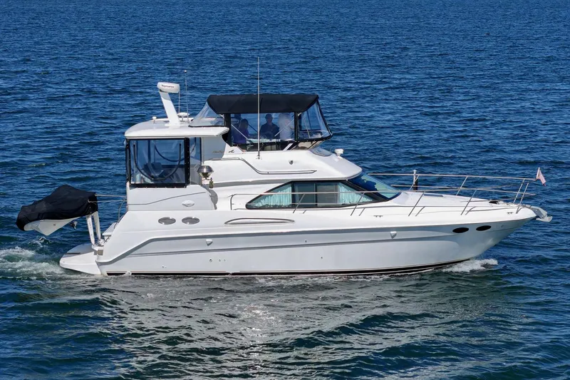 Slide: The Image of A white 1999 Sea Ray 370 Aft Cabin yacht cruising on calm waters. - 1