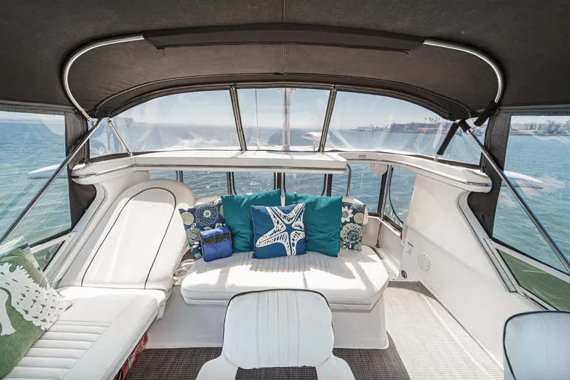 Slide: The Image of The image shows the spacious aft deck of a 1999 Sea Ray 370 Aft Cabin with comfortable seating. - 13