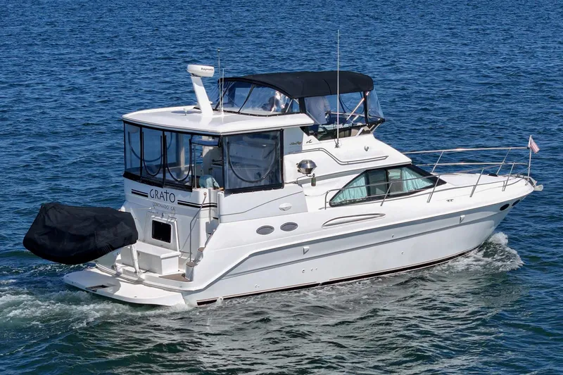 Slide: The Image of A white 1999 Sea Ray 370 Aft Cabin yacht cruising on calm waters. - 2