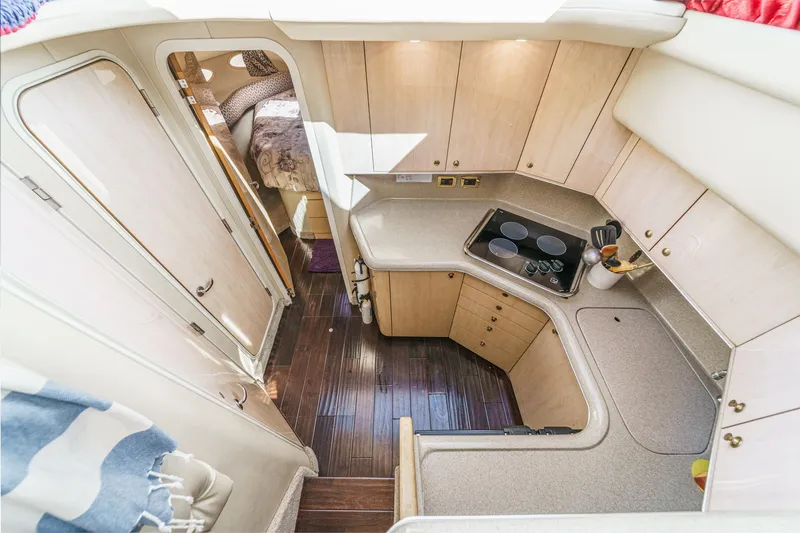 Slide: The Image of Interior view of a 1999 Sea Ray 370 Aft Cabin featuring a kitchen and sleeping area. - 33