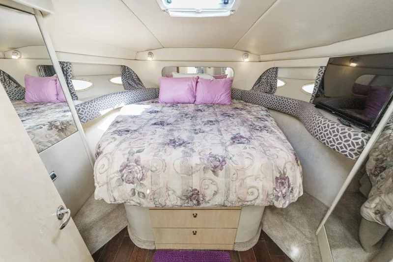 Slide: The Image of The image shows a cozy cabin with a large bed, mirrors, and a TV. - 43