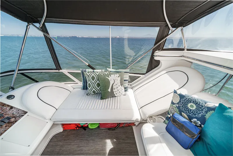 Slide: The Image of The image shows the cockpit of a 1999 Sea Ray 370 Aft Cabin with comfortable seating cushions. - 11