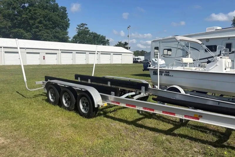 Slide: The Image of Trailer for 2025 Pursuit S 328 Sport boat beside parked RV. - 38