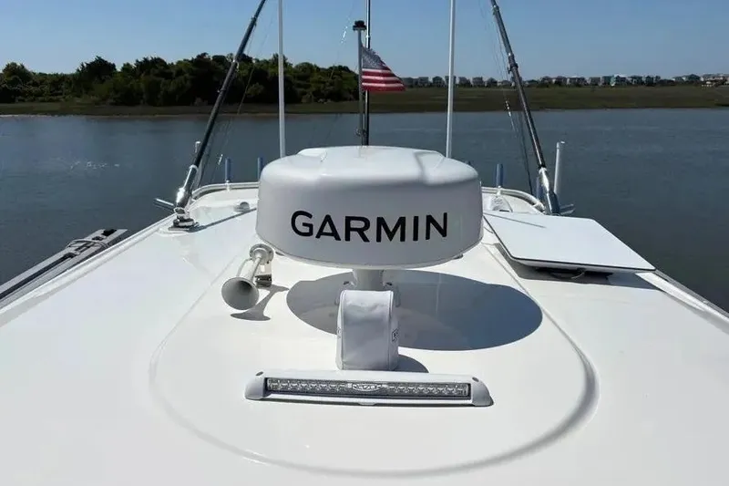 Slide: The Image of 2025 Pursuit S 328 Sport boat with Garmin radar on calm water. - 26