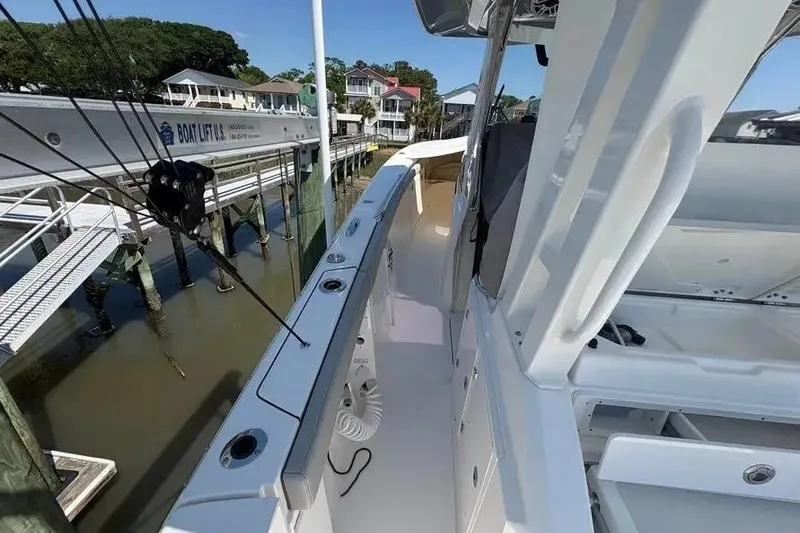 Slide: The Image of 2025 Pursuit S 328 Sport boat docked, showcasing sleek design and modern features. - 30
