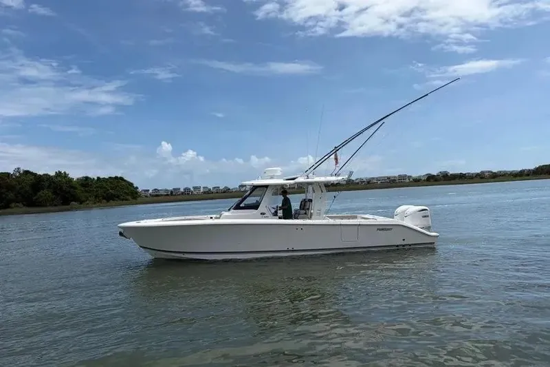 The Image of 2025 Pursuit S 328 Sport boat cruising on a calm river under a clear sky. - 1