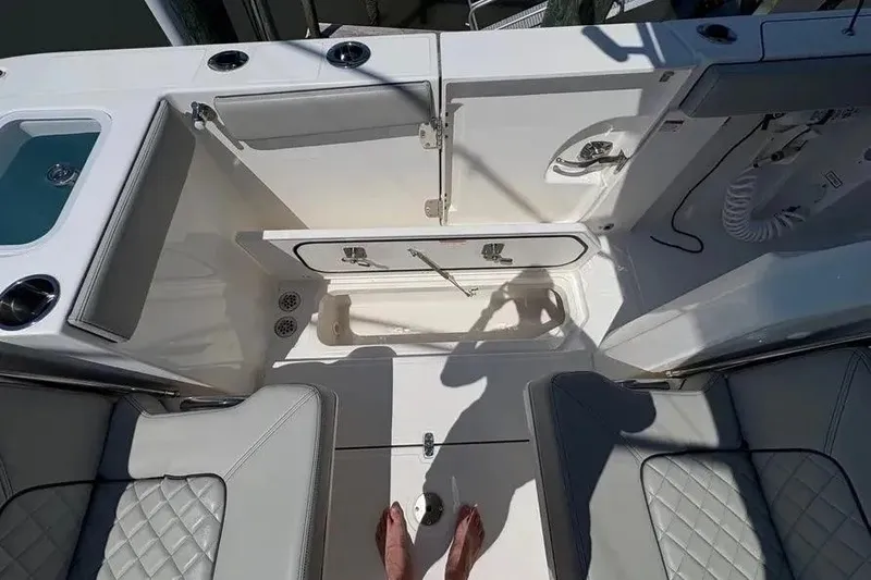 Slide: The Image of 2025 Pursuit S 328 Sport boat interior with seating and storage compartments. - 35