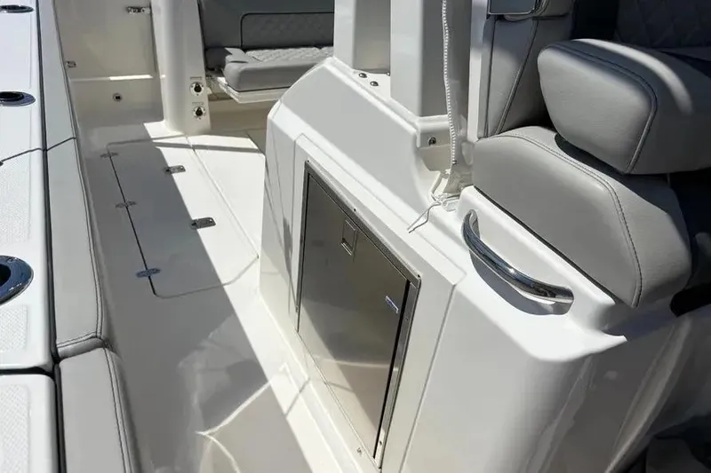 Slide: The Image of Interior view of 2025 Pursuit S 328 Sport boat, featuring sleek seating and storage. - 21