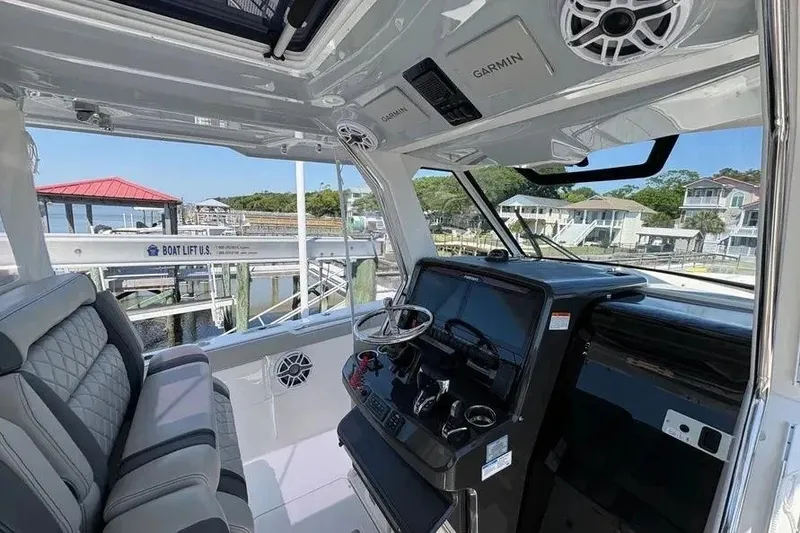Slide: The Image of Interior of 2025 Pursuit S 328 Sport boat with modern dashboard and seating. - 17