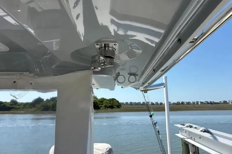Slide: The Image of 2025 Pursuit S 328 Sport boat detail with water and shoreline in background. - 20