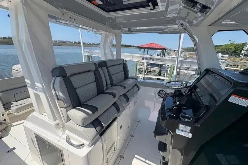 Slide: The Image of 2025 Pursuit S 328 Sport boat interior with luxurious seating and modern helm controls. - 14