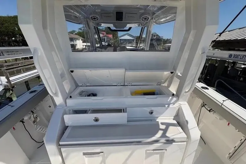 Slide: The Image of 2025 Pursuit S 328 Sport boat interior with storage compartments and sleek design. - 29