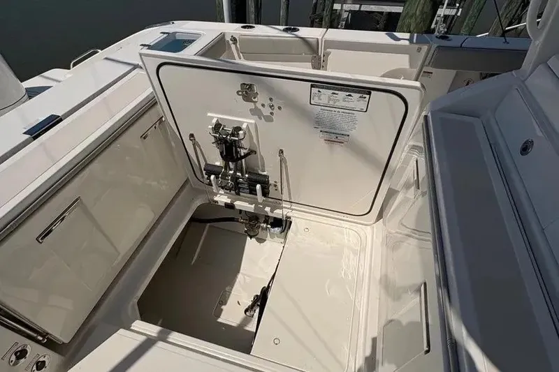Slide: The Image of 2025 Pursuit S 328 Sport boat interior with open hatch and visible mechanical components. - 36