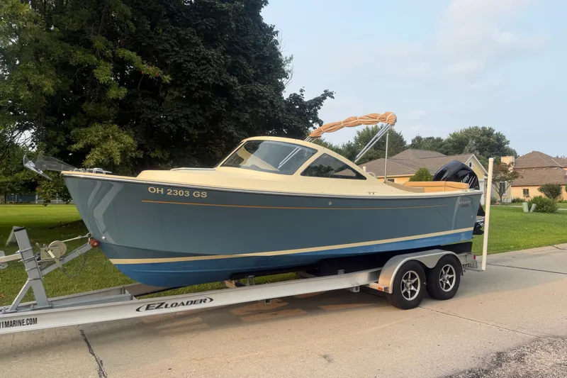 Slide: The Image of 2018 Vanquish Bristol Harbor 23 boat on trailer, parked in residential area. - 0