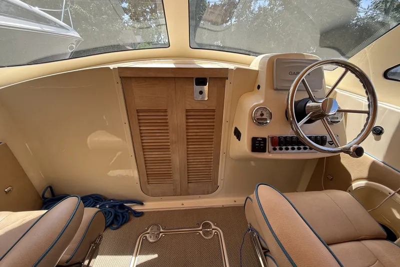 Slide: The Image of Interior of 2018 Vanquish Bristol Harbor 23 boat with steering wheel and dashboard controls. - 10