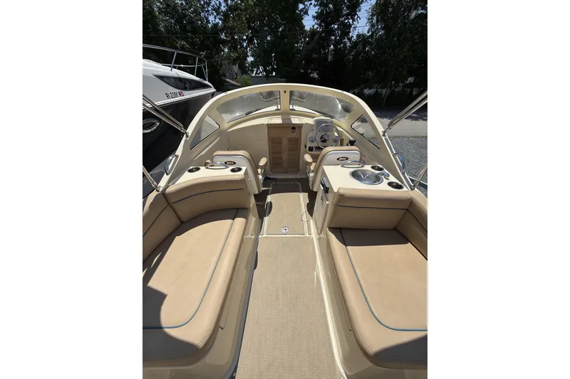Slide: The Image of 2018 Vanquish Bristol Harbor 23 boat interior with beige seating and steering console. - 8