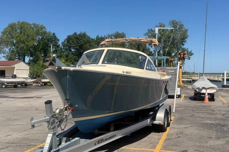 Slide: The Image of 2018 Vanquish Bristol Harbor 23 boat on trailer in marina parking lot. - 5