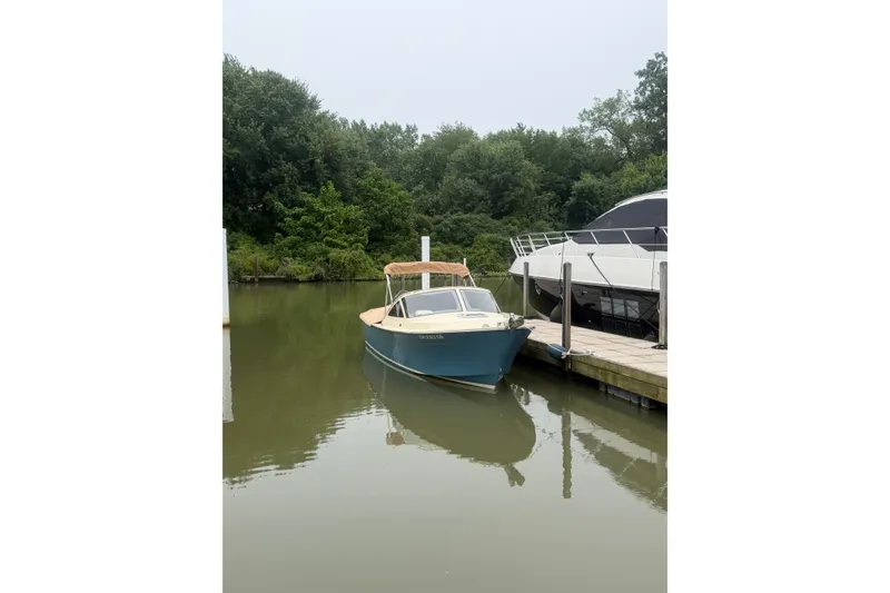 Slide: The Image of 2018 Vanquish Bristol Harbor 23 boat docked in a serene marina setting. - 3