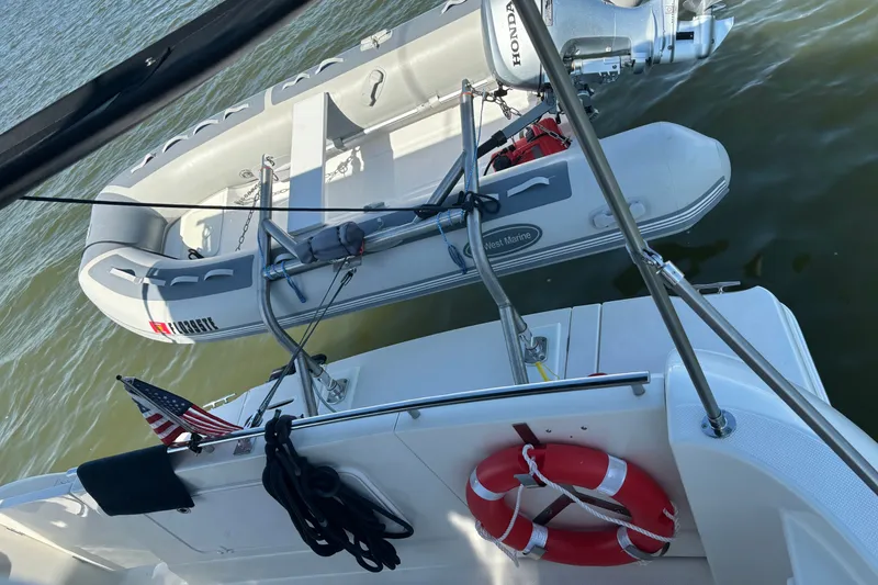 Slide: The Image of 2004 Meridian 459 Motoryacht with dinghy and American flag on water. - 41