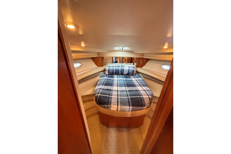 Slide: The Image of Cozy bedroom interior of 2004 Meridian 459 Motoryacht with plaid bedding and ambient lighting. - 22